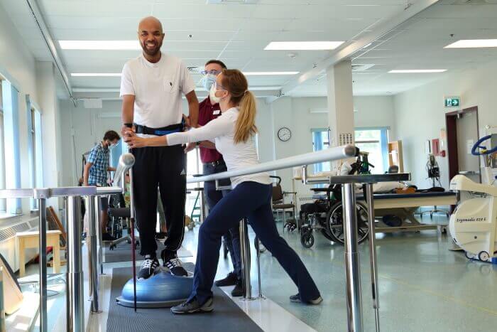 A picture of RHC staff assisting a patient on a therapy session 